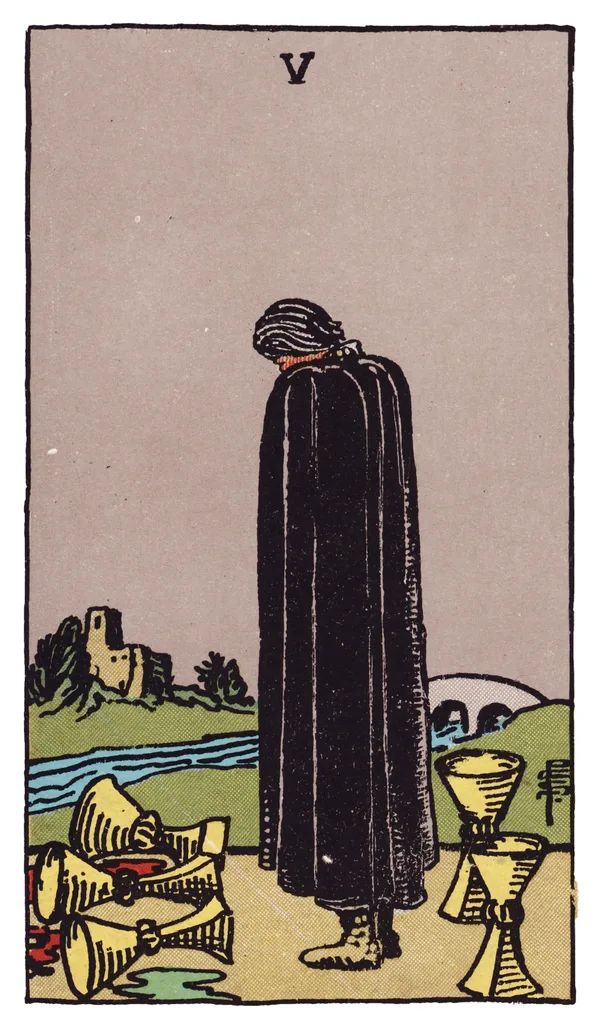 The Five of Cups from the Rider-Waite-Smith deck: a figure in a black cloak stands with head bowed before three overturned cups spilling dark liquid onto the ground, while two upright cups stand untouched behind him; a river and a distant bridge leading to a castle complete the scene.