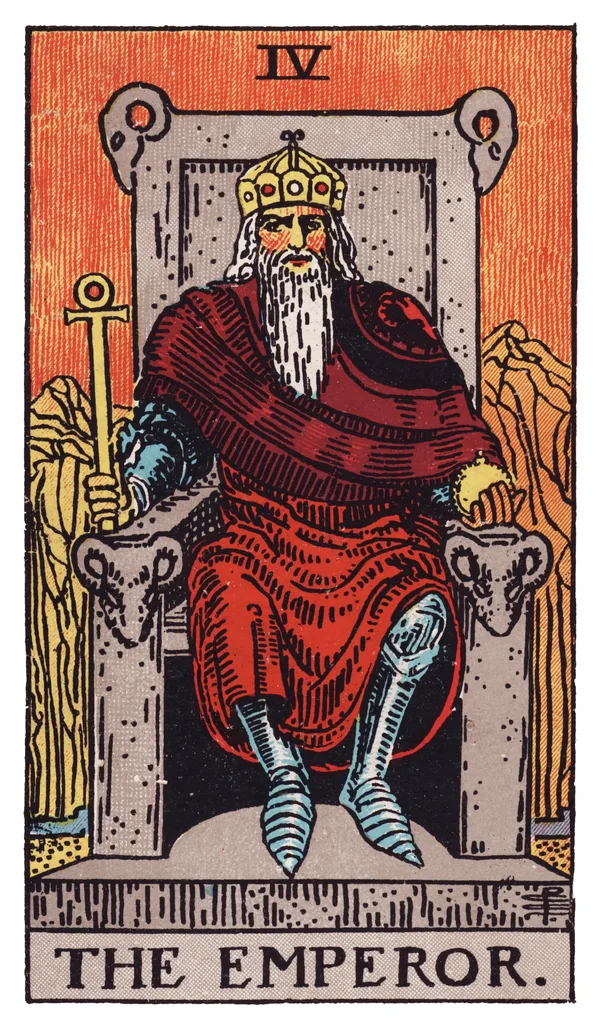 The Emperor from the Rider-Waite-Smith deck: a bearded older man in red robes and armor sits on a stone throne carved with four ram's heads, holding an ankh-topped scepter in one hand and a golden orb in the other, with barren, rocky red mountains rising behind him.