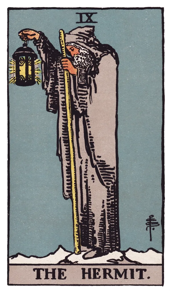 The Hermit from the Rider-Waite-Smith deck: an old, grey-bearded man in a hooded grey cloak stands alone on a snowy mountain peak, holding a lantern containing a six-pointed star high in one raised hand and a long wooden staff in the other, looking downward as if lighting the way for someone unseen behind him.