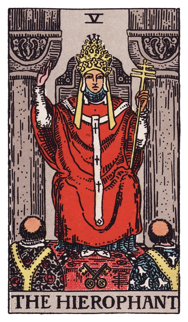 The Hierophant from the Rider-Waite-Smith deck: a robed figure wearing a triple-tiered papal crown sits enthroned between two grey pillars, right hand raised in a two-fingered gesture of benediction, a triple-barred cross staff in his left hand, two crossed keys resting at the base of his throne, and two tonsured acolytes kneeling before him, their robes patterned with lilies and roses.