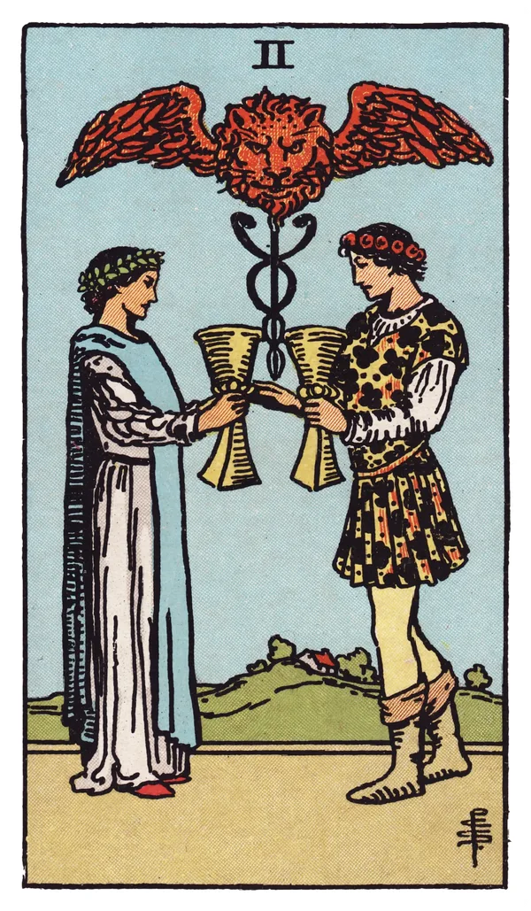 The Two of Cups from the Rider-Waite-Smith deck: a man and a woman face each other, each raising a cup toward the other in a mutual toast, crowned with laurel and flowers; between and above them a winged caduceus topped by a small lion's head rises from a grassy mound.